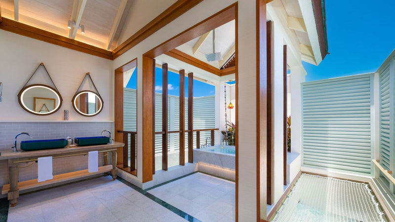 OBLU SELECT Lobigili, North Malé Atoll: a villa bathroom with twin basins opening to the outside