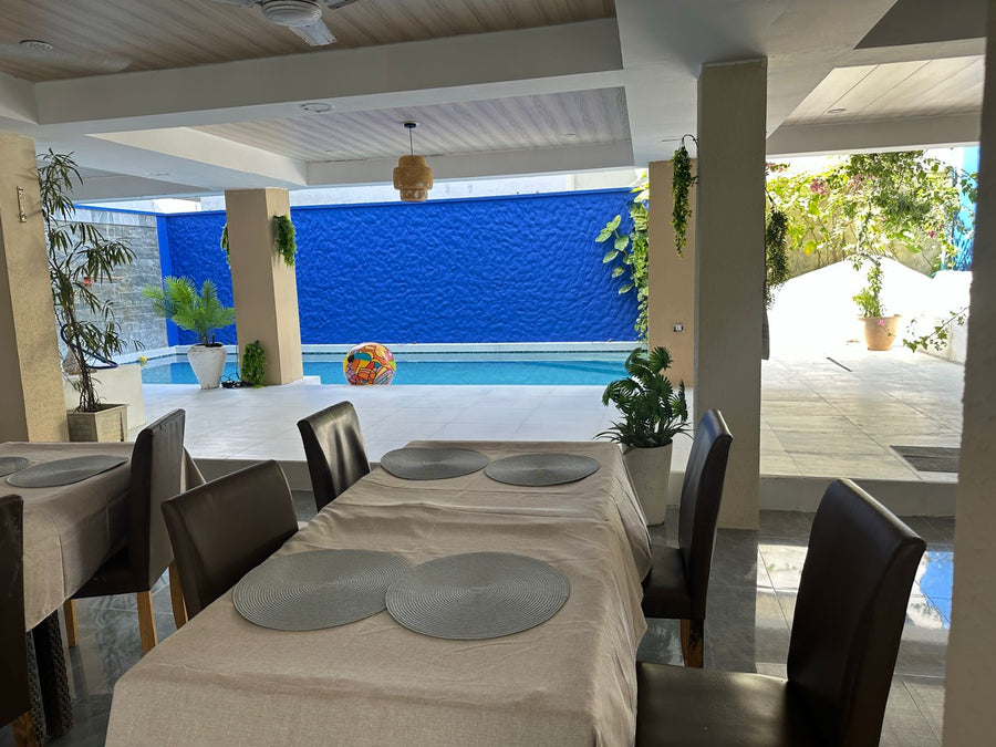 Dining tables beside the pool at KUE Hotel