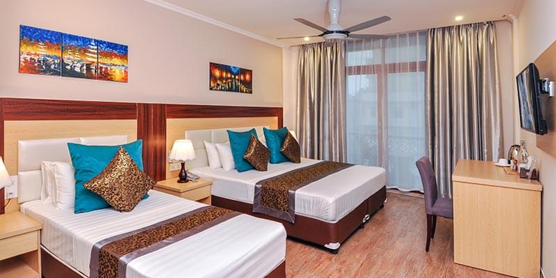 Room at Triton Beach Hotel opening onto a balcony