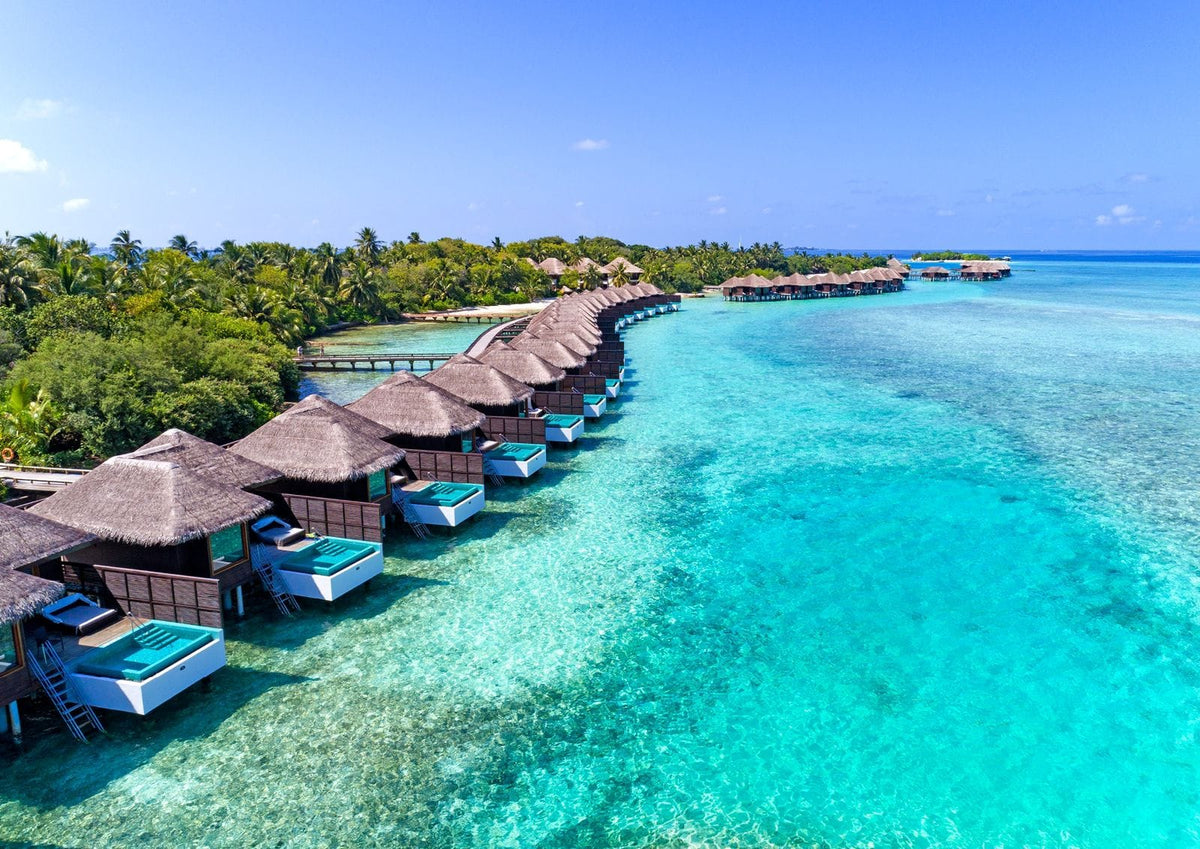 Sheraton Maldives Full Moon Resort & Spa, thatched overwater villas in a line above turquoise water