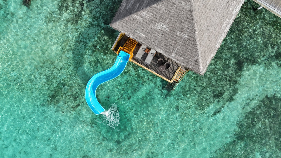An overwater Lagoon Suite with Slide at Cocoon Maldives