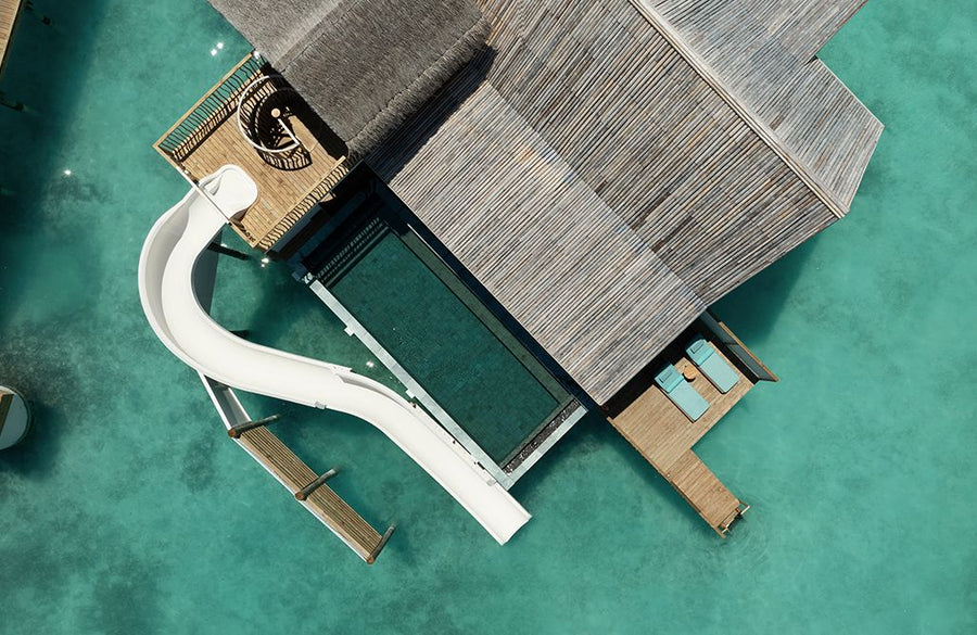 An overwater villa with a water slide at RAH GILI Maldives from the air