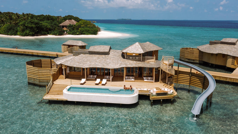 A One Bedroom Water Reserve at Soneva Fushi, an overwater villa with a private pool and a slide into the lagoon
