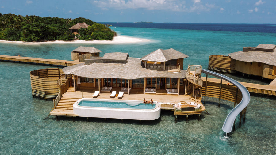 A One Bedroom Water Reserve at Soneva Fushi, an overwater villa with a private pool and a slide into the lagoon