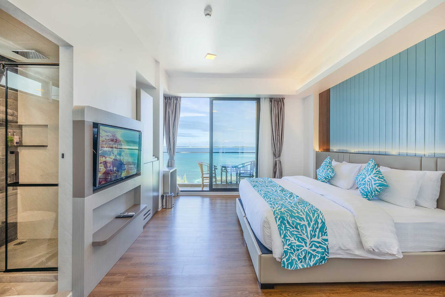 Standard Deluxe room at Arena Beach Hotel with a double bed and balcony doors