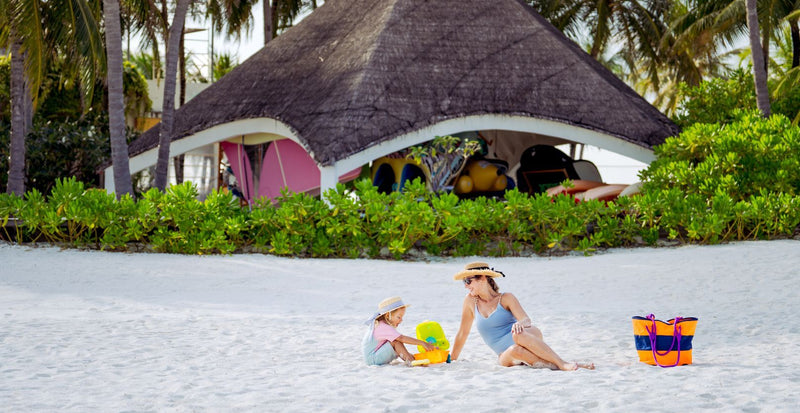 OBLU SELECT Sangeli, North Malé Atoll: a mother and child building sandcastles in front of the kids' club