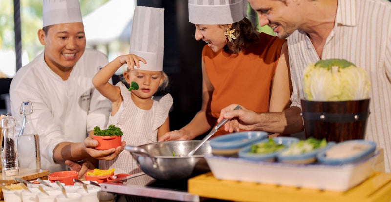 OBLU SELECT Sangeli, North Malé Atoll: a chef cooking with a child and her parents at a live station