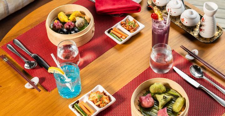 OBLU SELECT Sangeli, North Malé Atoll: a table laid with Asian dishes, dim sum and cocktails