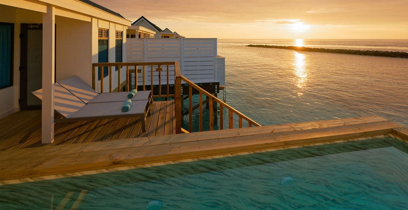 OBLU NATURE Helengeli by SENTIDO, North Malé Atoll: a water villa deck and pool at sunset