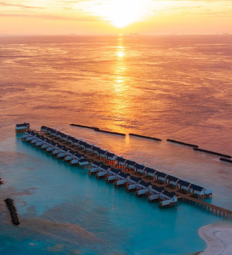 OBLU NATURE Helengeli by SENTIDO, North Malé Atoll: from the air, the line of water villas at sunset