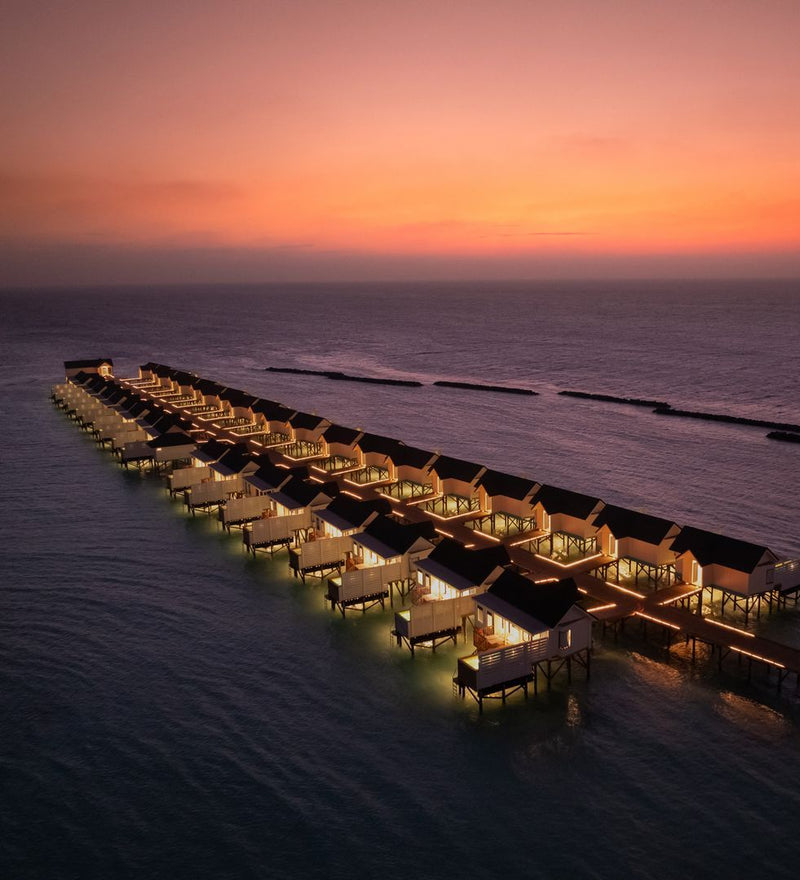 OBLU NATURE Helengeli by SENTIDO, North Malé Atoll: from the air, the water villas lit up at dusk