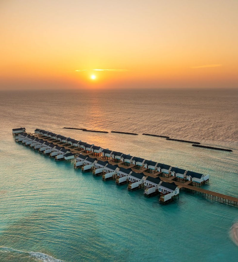 OBLU NATURE Helengeli by SENTIDO, North Malé Atoll: from the air, the water villas and breakwater at sunset