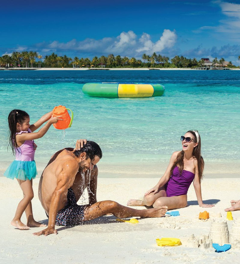 OBLU Xperience Ailafushi, North Malé Atoll: a mother and daughter playing in the lagoon shallows