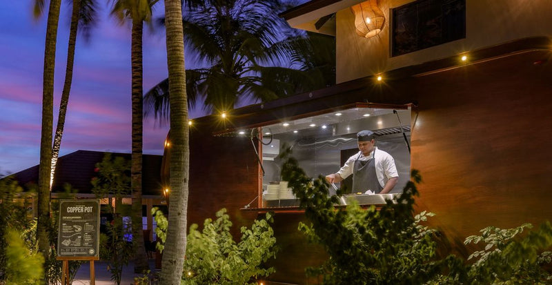 OBLU Xperience Ailafushi, North Malé Atoll: a chef at a food truck in the garden at night