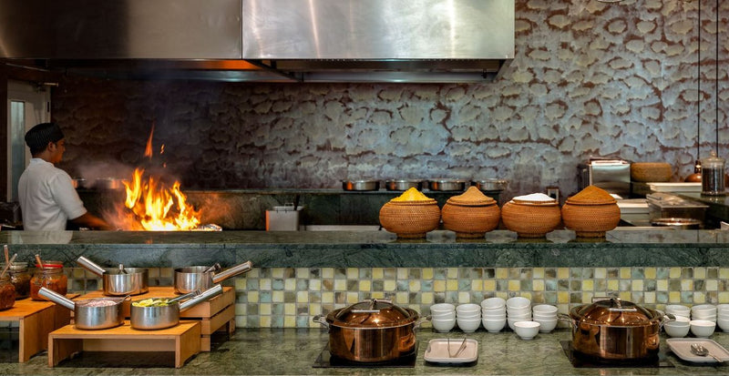 OBLU Xperience Ailafushi, North Malé Atoll: a chef at a wood-fired grill