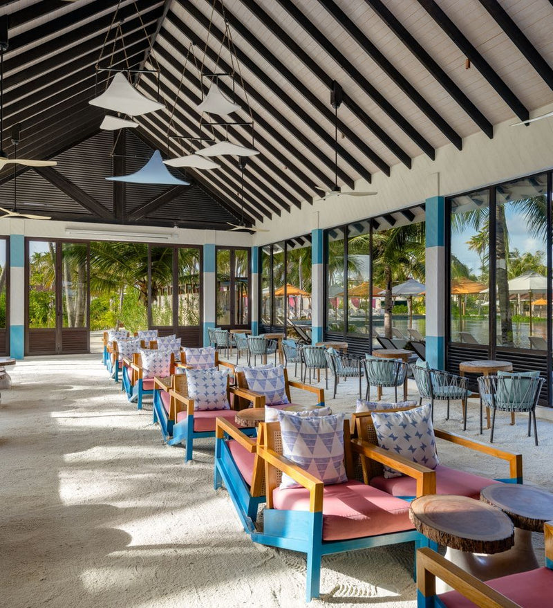 OBLU Xperience Ailafushi, North Malé Atoll: an open-sided dining terrace looking onto the gardens