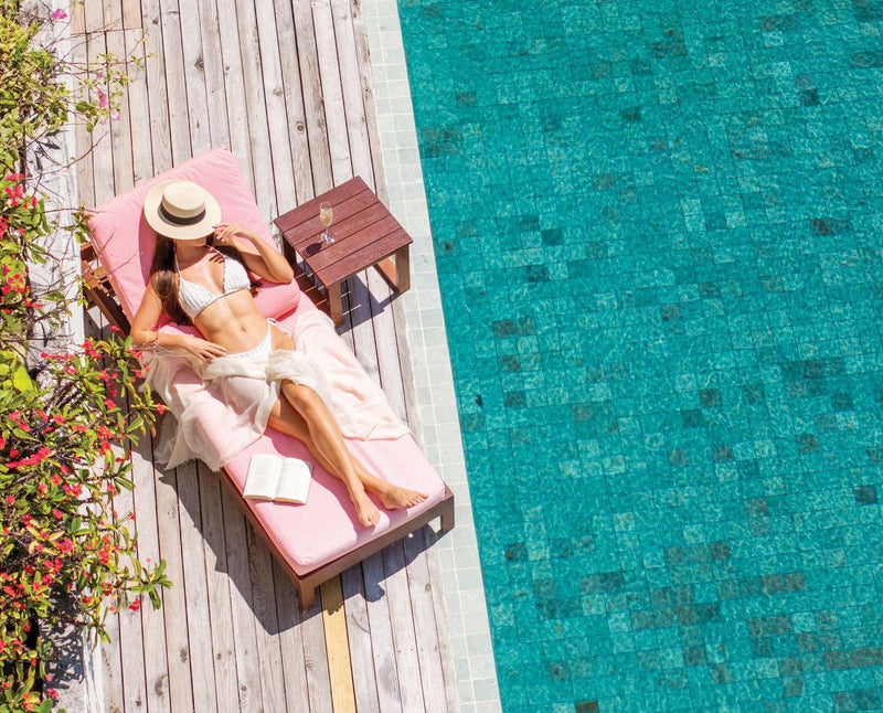 VARU by Atmosphere, North Malé Atoll: a guest on a lounger beside a villa pool