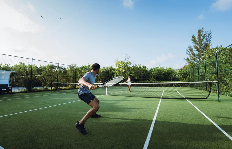 VARU by Atmosphere, North Malé Atoll: a guest playing on the tennis court