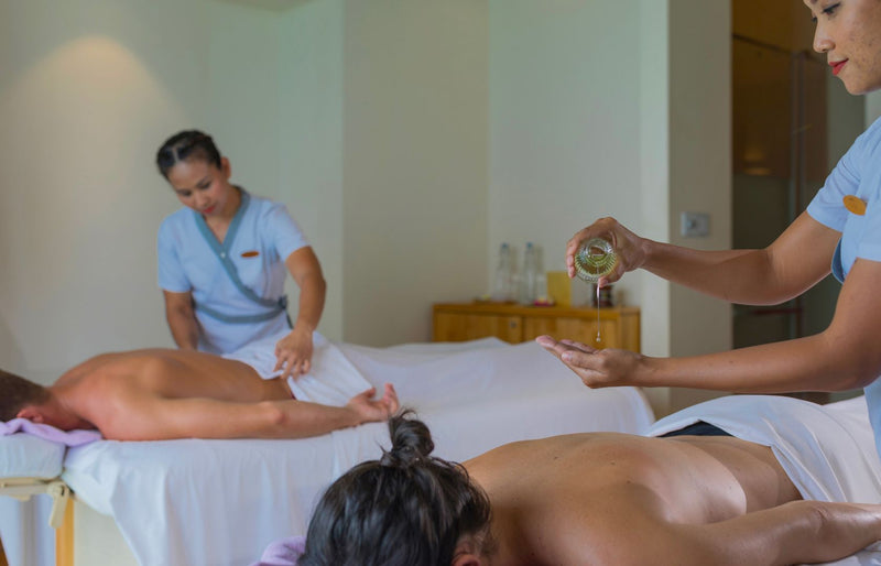 VARU by Atmosphere, North Malé Atoll: a therapist pouring oil during a couple's massage