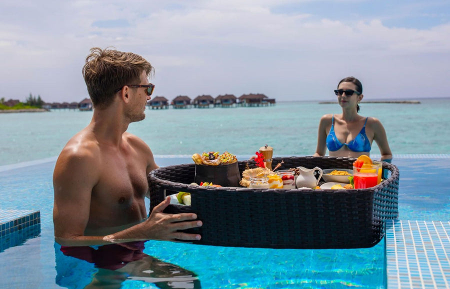 VARU by Atmosphere, North Malé Atoll: a floating breakfast in the main pool, the water villas behind