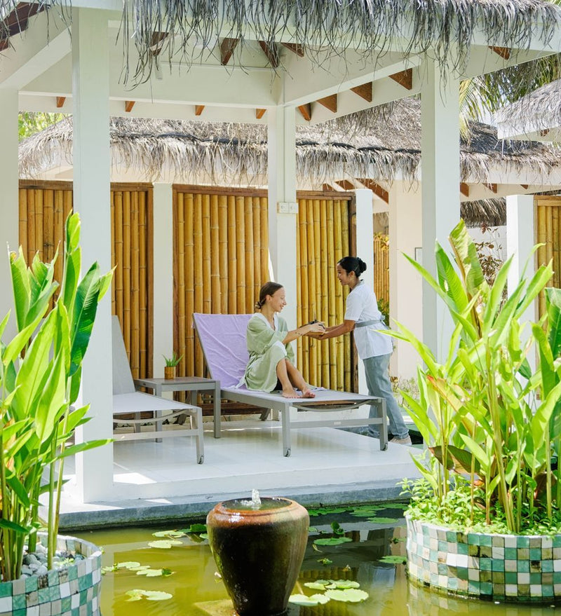 OBLU NATURE Helengeli by SENTIDO, North Malé Atoll: a therapist greeting a guest in the spa garden