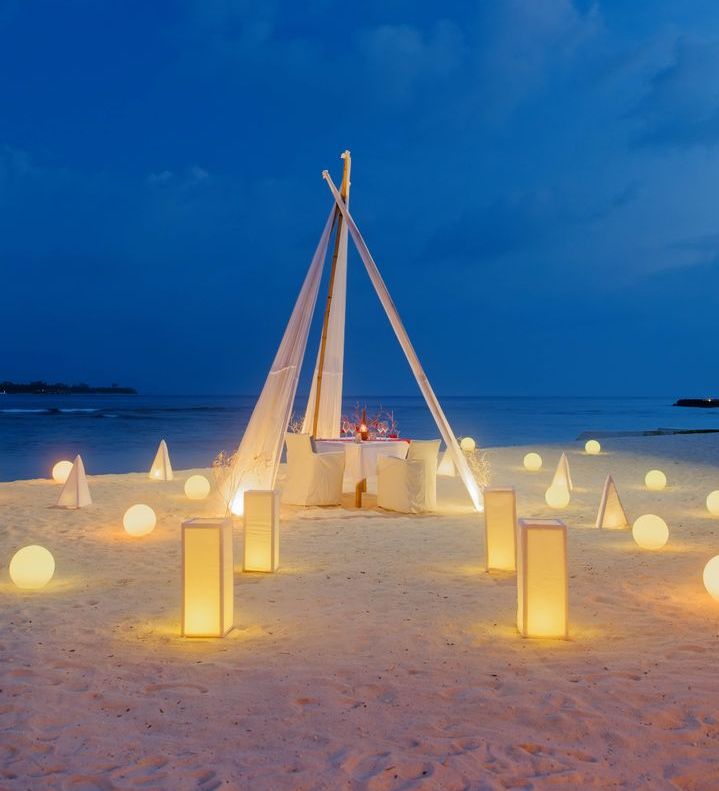 OBLU NATURE Helengeli by SENTIDO, North Malé Atoll: a candlelit dinner table on the beach at night