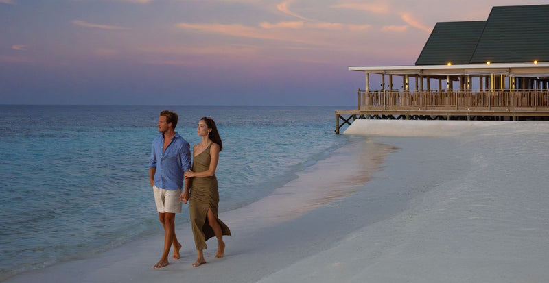 OBLU NATURE Helengeli by SENTIDO, North Malé Atoll: a couple walking on the beach at dusk