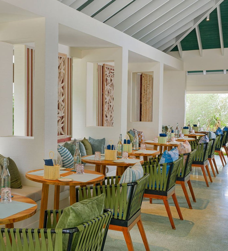 OBLU NATURE Helengeli by SENTIDO, North Malé Atoll: a dining room with carved screens and cushioned chairs