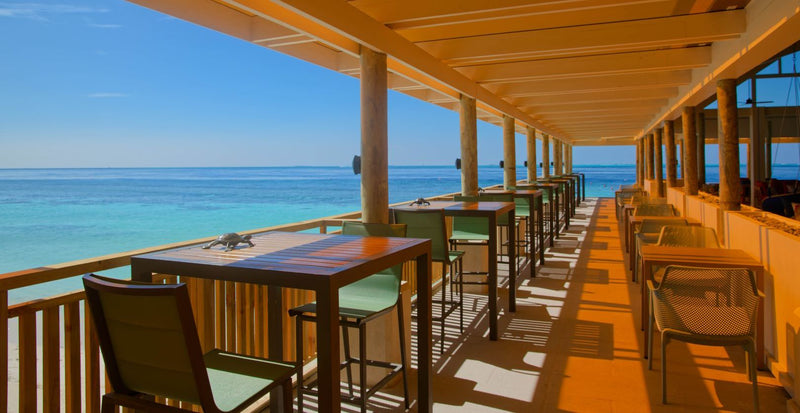 OBLU NATURE Helengeli by SENTIDO, North Malé Atoll: a long covered terrace of tables facing the sea