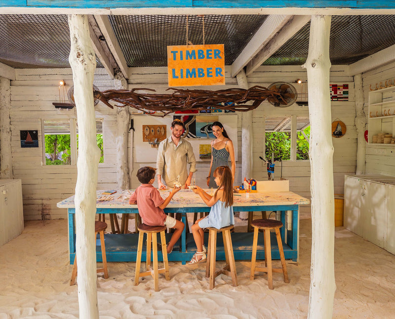 RAAYA by Atmosphere, Raa Atoll: a family at a craft table in the artists' workshop