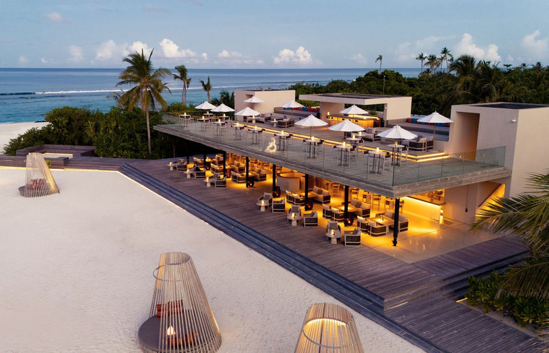 RAAYA by Atmosphere, Raa Atoll: a rooftop restaurant and bar lit up at dusk