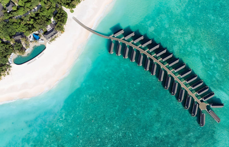 RAAYA by Atmosphere, Raa Atoll: from above, the curve of the water villa jetty