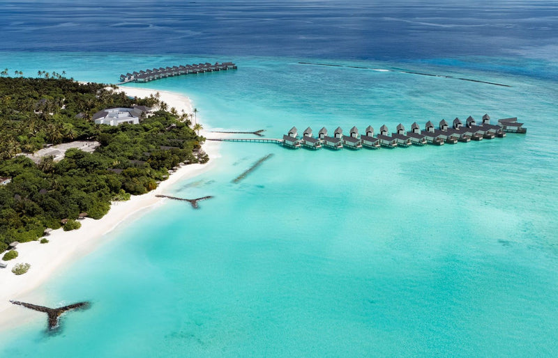 RAAYA by Atmosphere, Raa Atoll: from the air, the island's edge and two water villa jetties