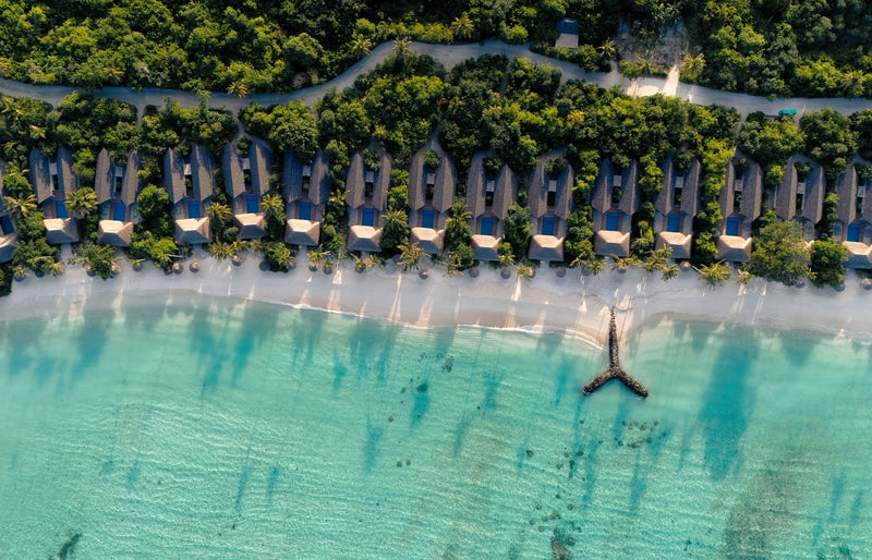 RAAYA by Atmosphere, Raa Atoll: from above, a row of beach villas behind the sand