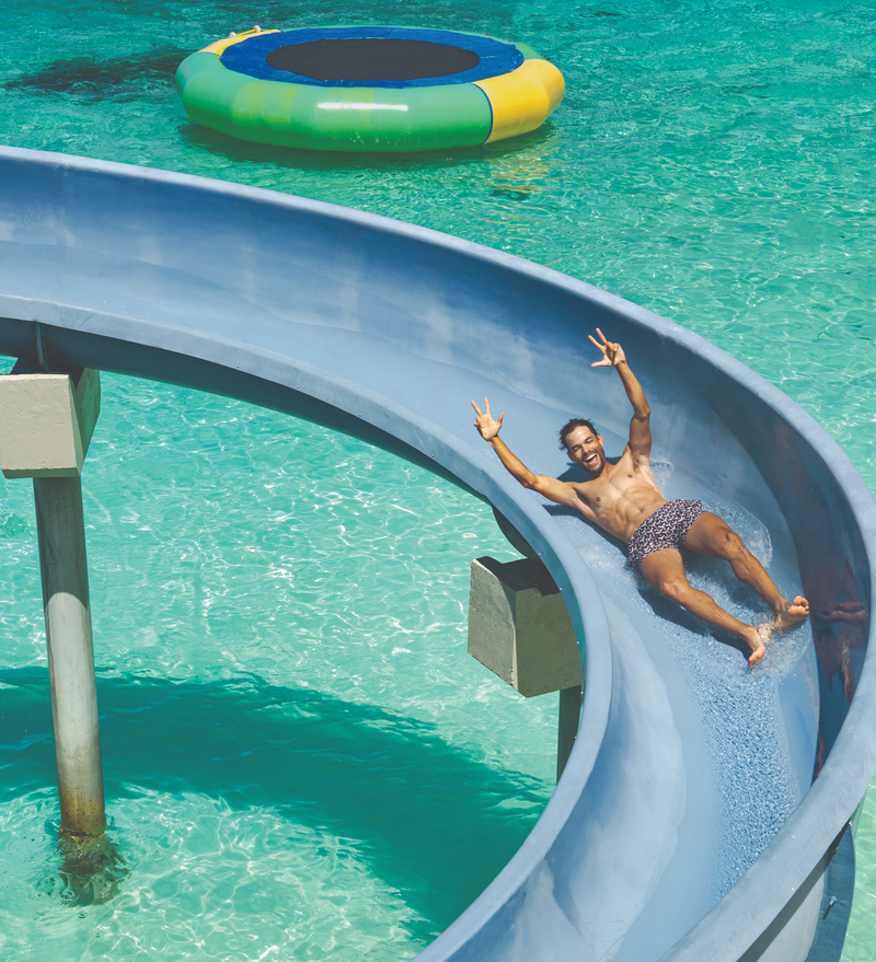 OBLU Xperience Ailafushi, North Malé Atoll: a guest coming down a water slide