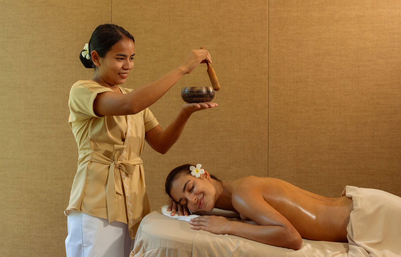 RAAYA by Atmosphere, Raa Atoll: a therapist pouring oil during a spa treatment