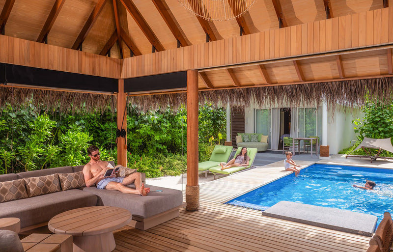 RAAYA by Atmosphere, Raa Atoll: the covered terrace and private pool of a two-bedroom beach villa, a family swimming