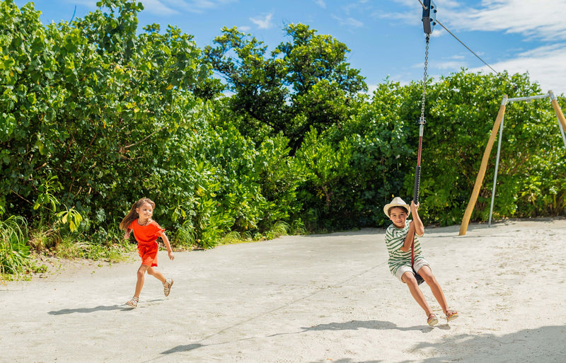 RAAYA by Atmosphere, Raa Atoll: children on a zipline and swing on the beach