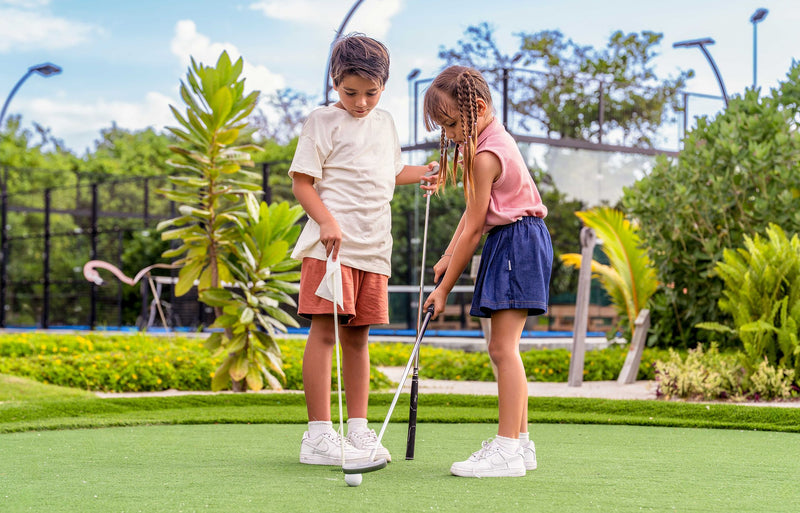 RAAYA by Atmosphere, Raa Atoll: two children playing mini golf
