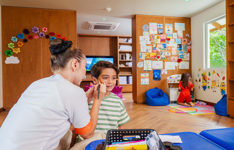 RAAYA by Atmosphere, Raa Atoll: a child having his face painted at the kids' club