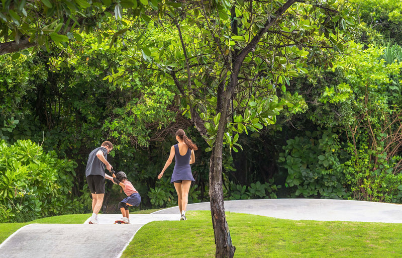 RAAYA by Atmosphere, Raa Atoll: a family walking on a path through the island's trees