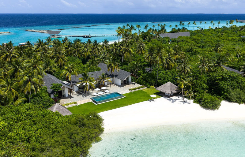 RAAYA by Atmosphere, Raa Atoll: from the air, a large private residence with a pool and lawn by the beach