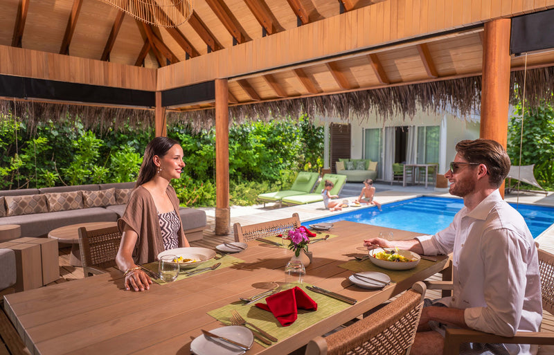 RAAYA by Atmosphere, Raa Atoll: a couple dining by a villa pool