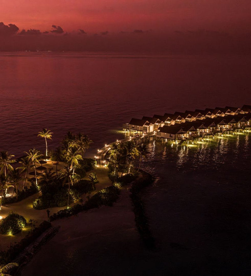 OBLU SELECT Lobigili, North Malé Atoll: the overwater villas lit up at night