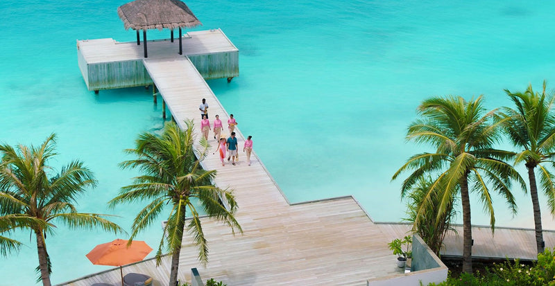 OBLU SELECT Lobigili, North Malé Atoll: guests on the jetty to an overwater pavilion