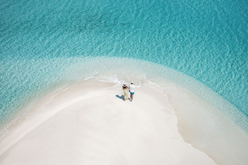 Two guests on the sandbank at RAH GILI Maldives.