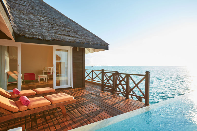 The wraparound deck and infinity pool edge of a Grand Water Villa with Pool at Sun Siyam Vilu Reef