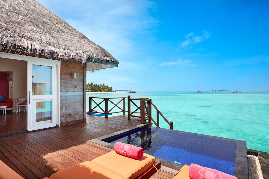 The plunge pool and deck of a Water Villa with Pool at Sun Siyam Vilu Reef, over the lagoon