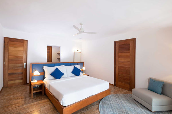 The bedroom of a Sunset Beach Suite at Ifuru Island Maldives.
