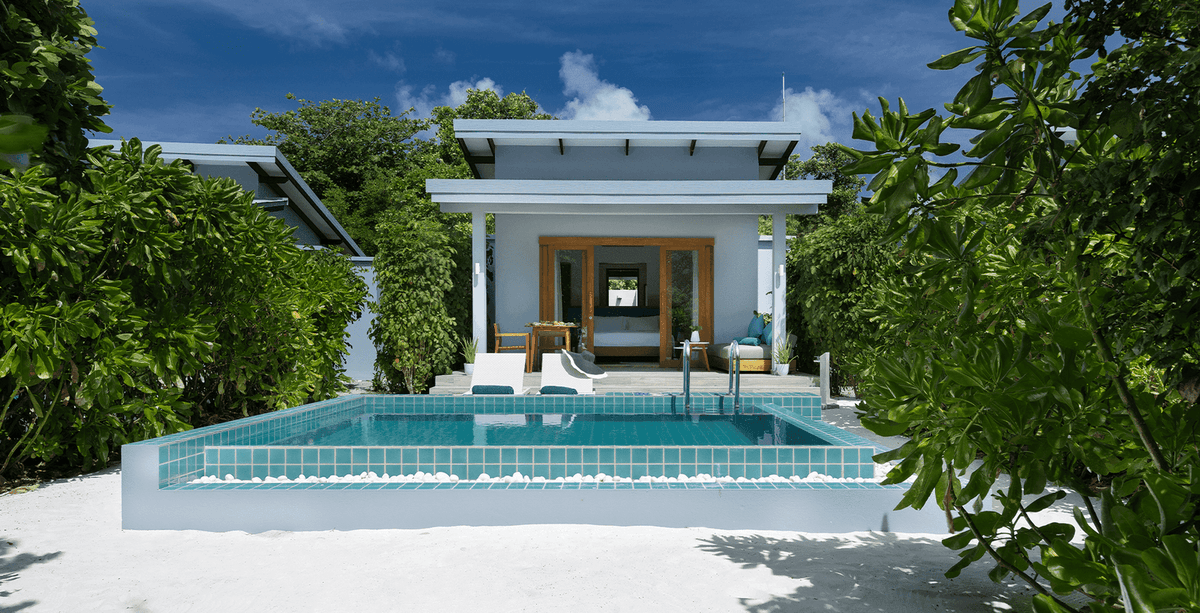 A beach villa at Ifuru Island Maldives seen from outside, with its private pool and deck.
